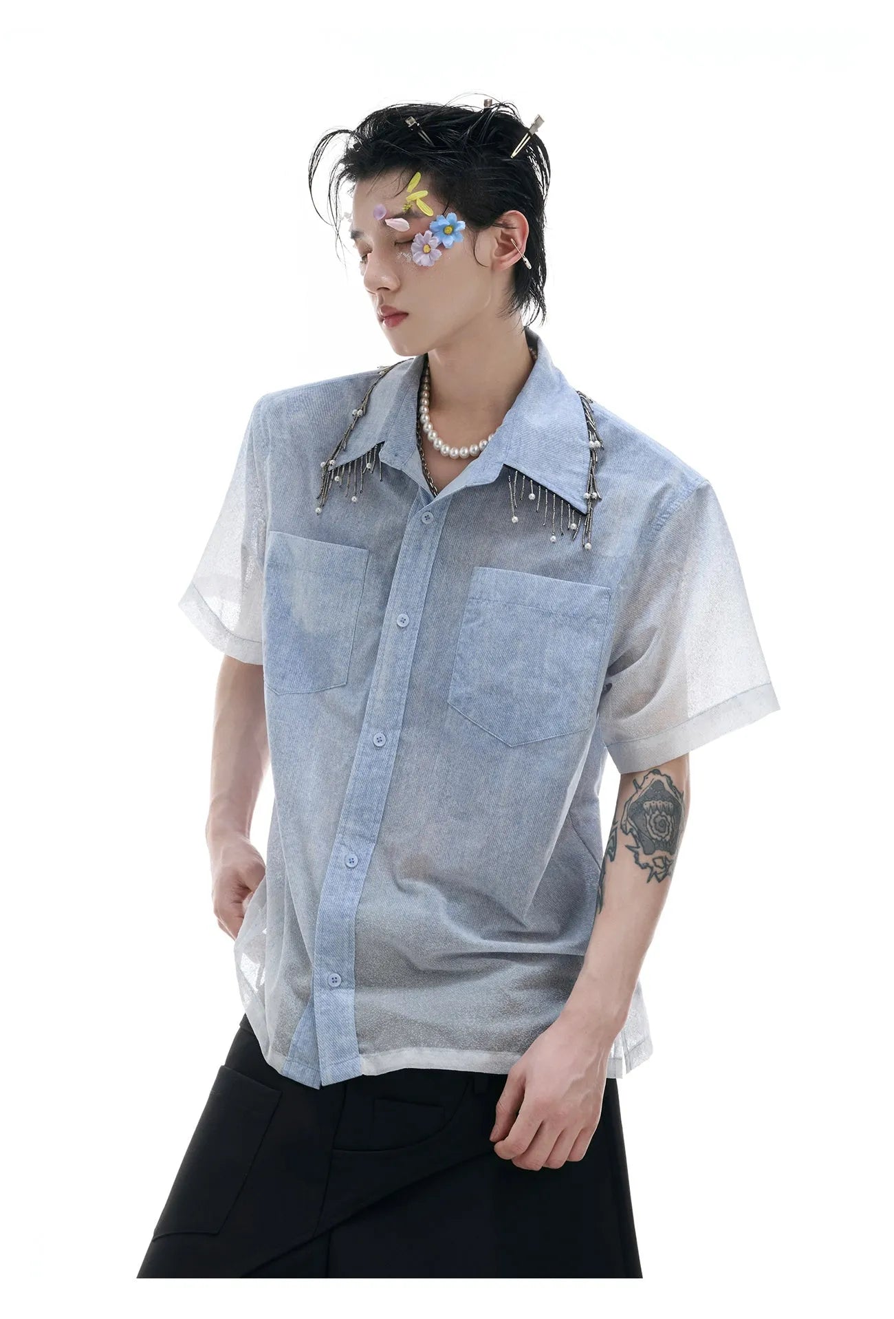 Man modelling a loose fit blue and white gradient shirt with quilted detailing and short sleeves.
