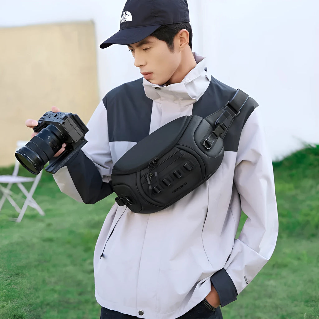 Black waterproof Oxford cloth shoulder camera bag worn across the chest.