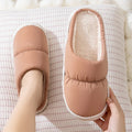 Blue down cotton winter slippers with thick rubber sole and plush lining for indoor use.