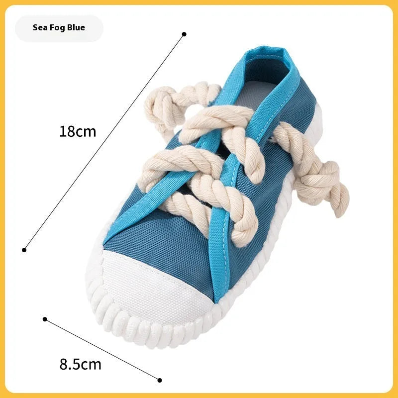 Slipper-shaped plastic dog chew toy with a squeaker, shown in yellow, black, and blue colour options.