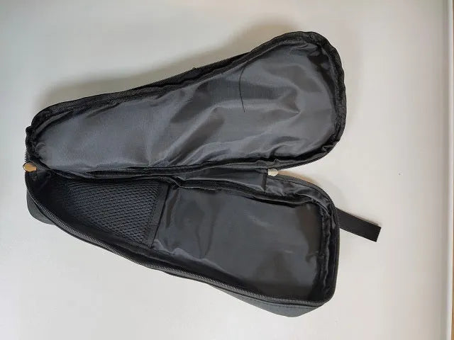Black drawstring storage bag for mobile phone gimbal accessories on a table.