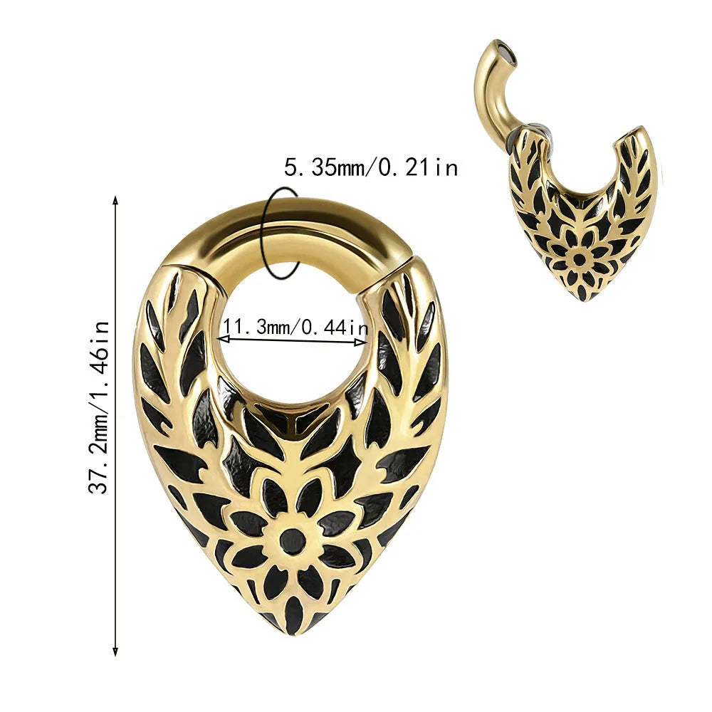 A stainless steel drop-shaped ear extender with totem detailing for 0 gauge stretched earlobes.
