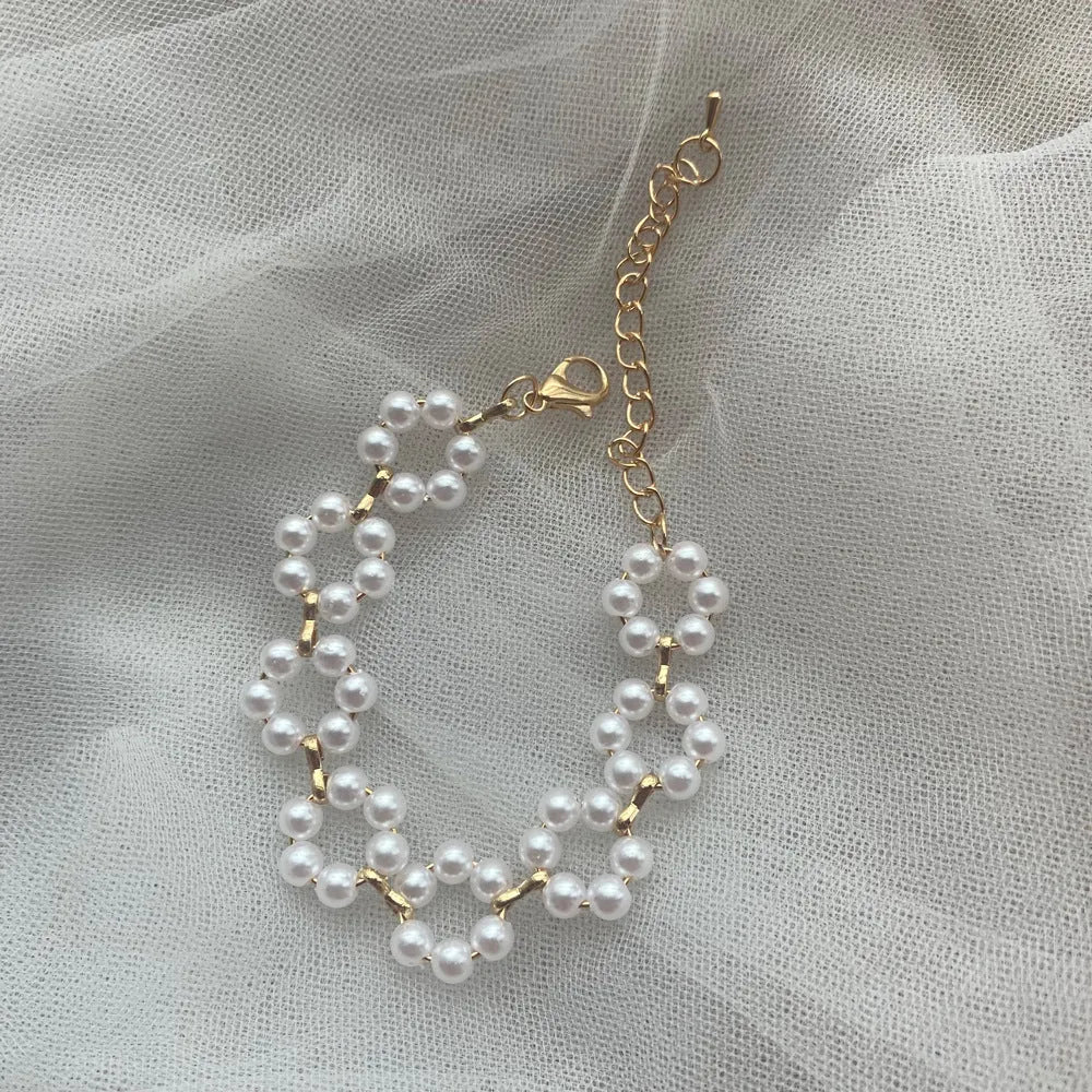Pearl necklace and bracelet set for women on white background