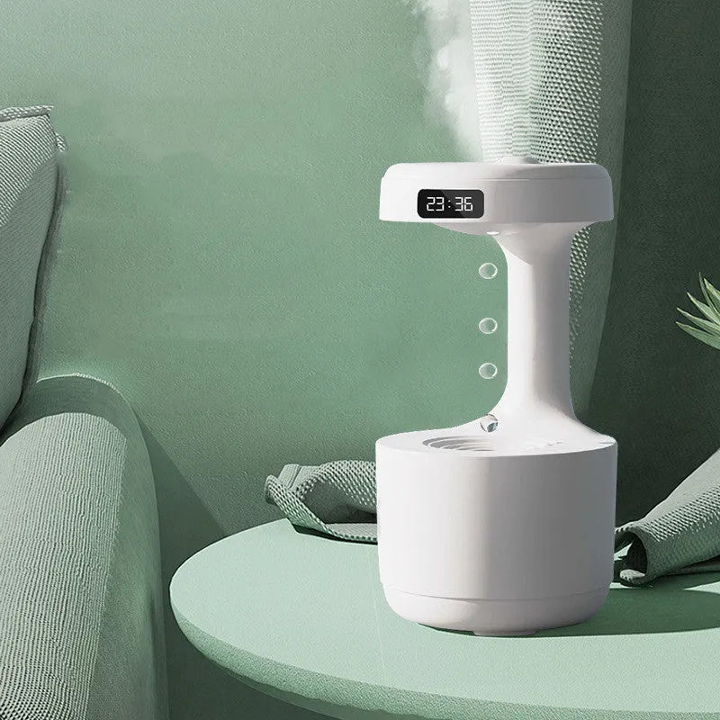 White columnar anti-gravity humidifier with LED clock display and mist output on a wooden desk.