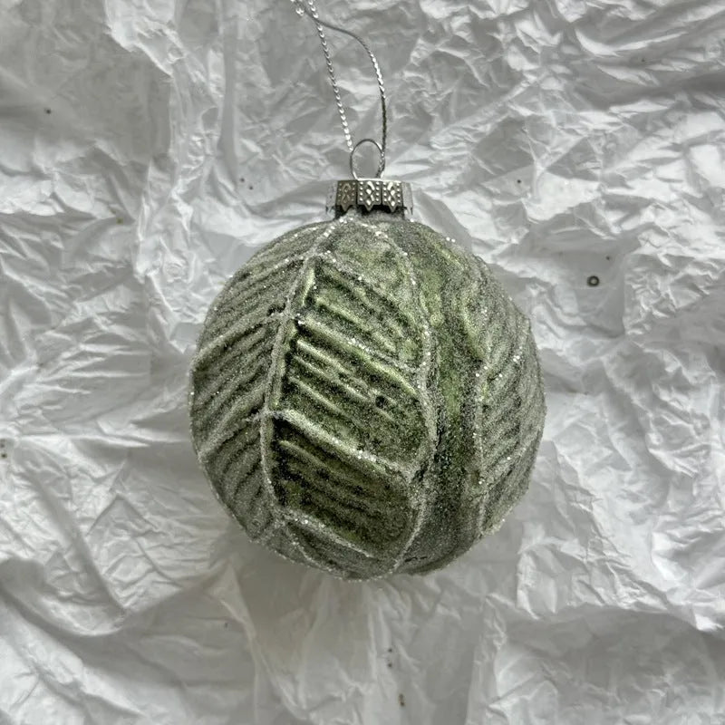 Handmade glass Christmas bauble 8cm diameter in green on branch