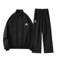 Pink and black waterproof cotton blend winter ski suit jacket and trousers set on hanger