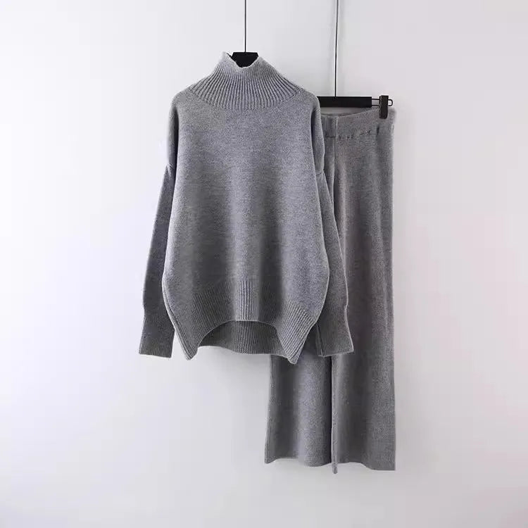 Women's milky white acrylic knit sweater and wide-leg trouser two-piece set on a hanger.