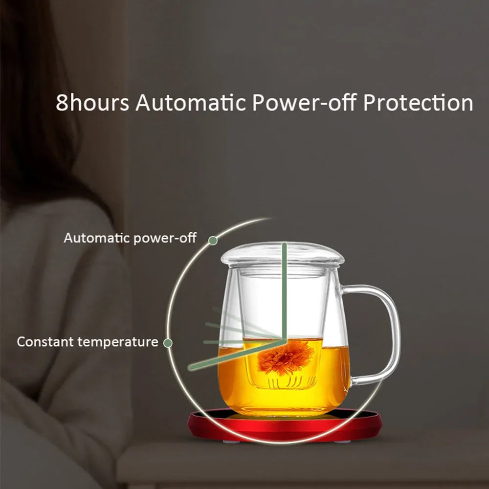 Black USB-powered beverage heating coaster with touch control and coloured LED lights on a wooden desk.