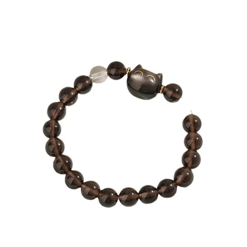 Women's silver bracelet with 8mm opal cat head charm on wrist