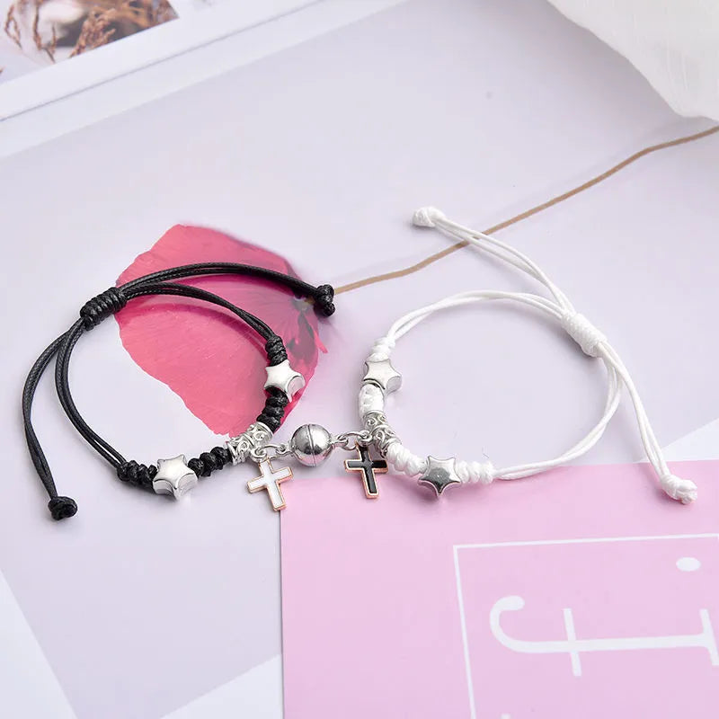 A pair of magnet couple bracelets in alloy with electroplated finish, showing styles like crown, clover, and love lock.