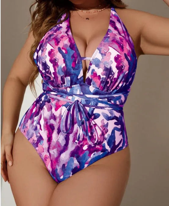 Women's solid blue halter neck one-piece swimsuit on a mannequin, showing the briefs style bottom.
