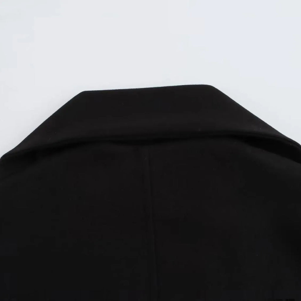 Women's long black polyester overcoat with a detachable artificial fur collar in a street fashion style.