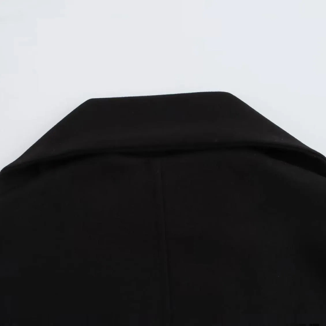 Women's long black polyester overcoat with a detachable artificial fur collar in a street fashion style.