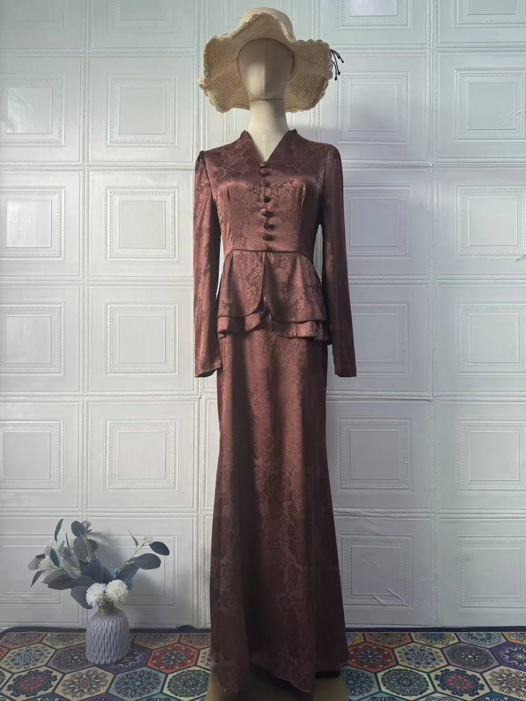Dark brown retro dress with floral print, long sleeves, and button detailing on hanger