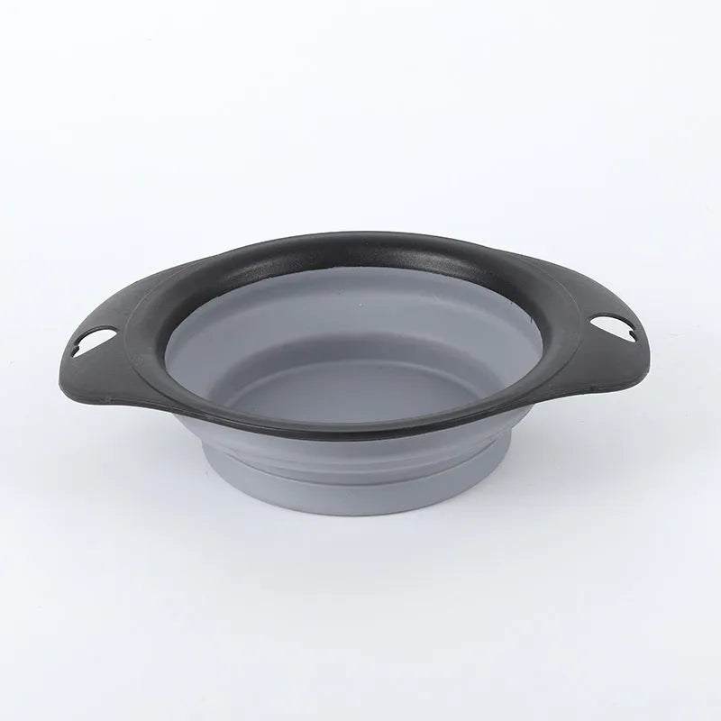 Black silicone pet bowl shown open and folded flat next to a dog leash.