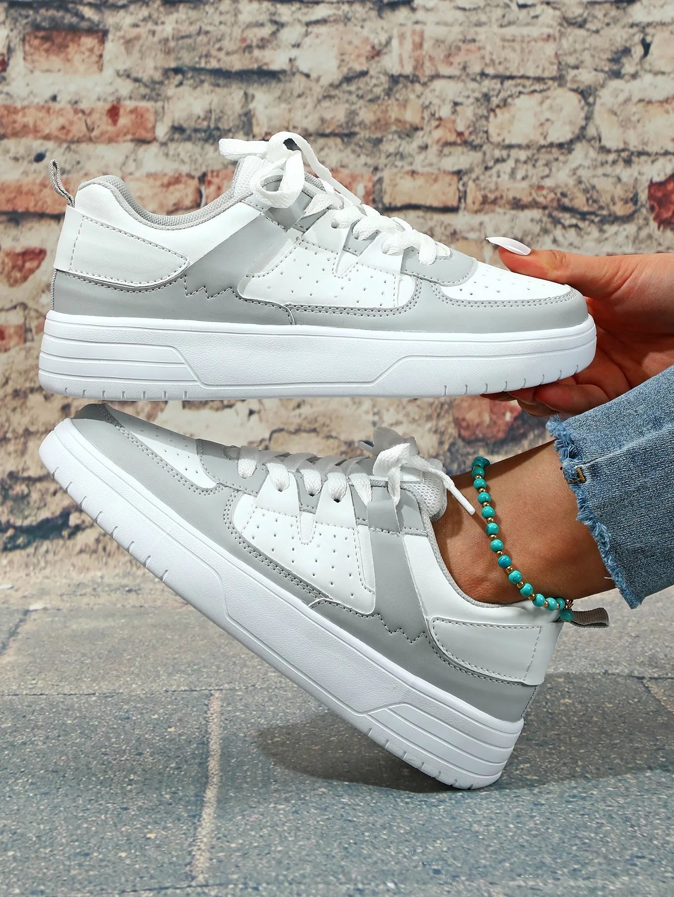 Pair of solid colour low heel lace-up board shoes with artificial PU upper and rubber sole