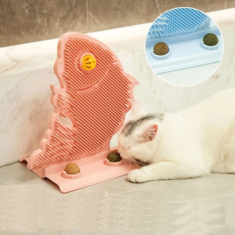 Blue fish-shaped cat wall scratcher toy with brush, catnip balls, and a bell on a white base.