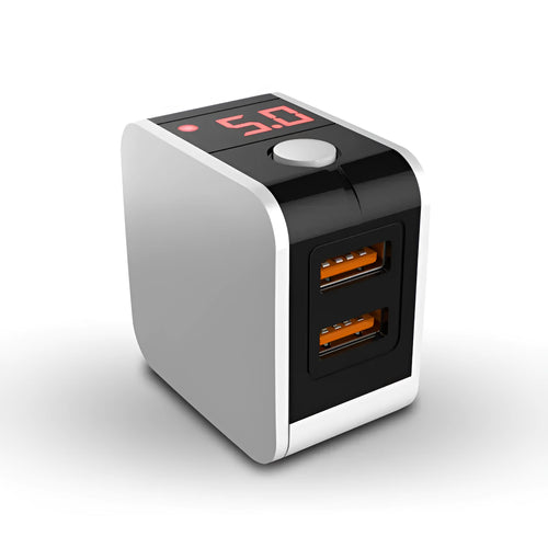 A black dual USB travel charger with a digital display showing '5V', plugged into a UK wall socket.
