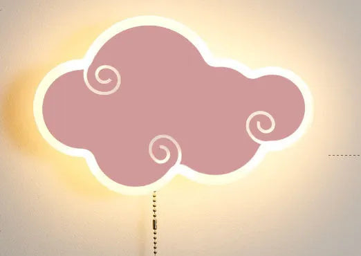 Modern white cloud-shaped acrylic wall lamp lit with a soft warm glow on a bedroom wall.