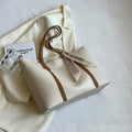Large soft crossbody tote bag in bucket design showing colour options and internal zipped pocket