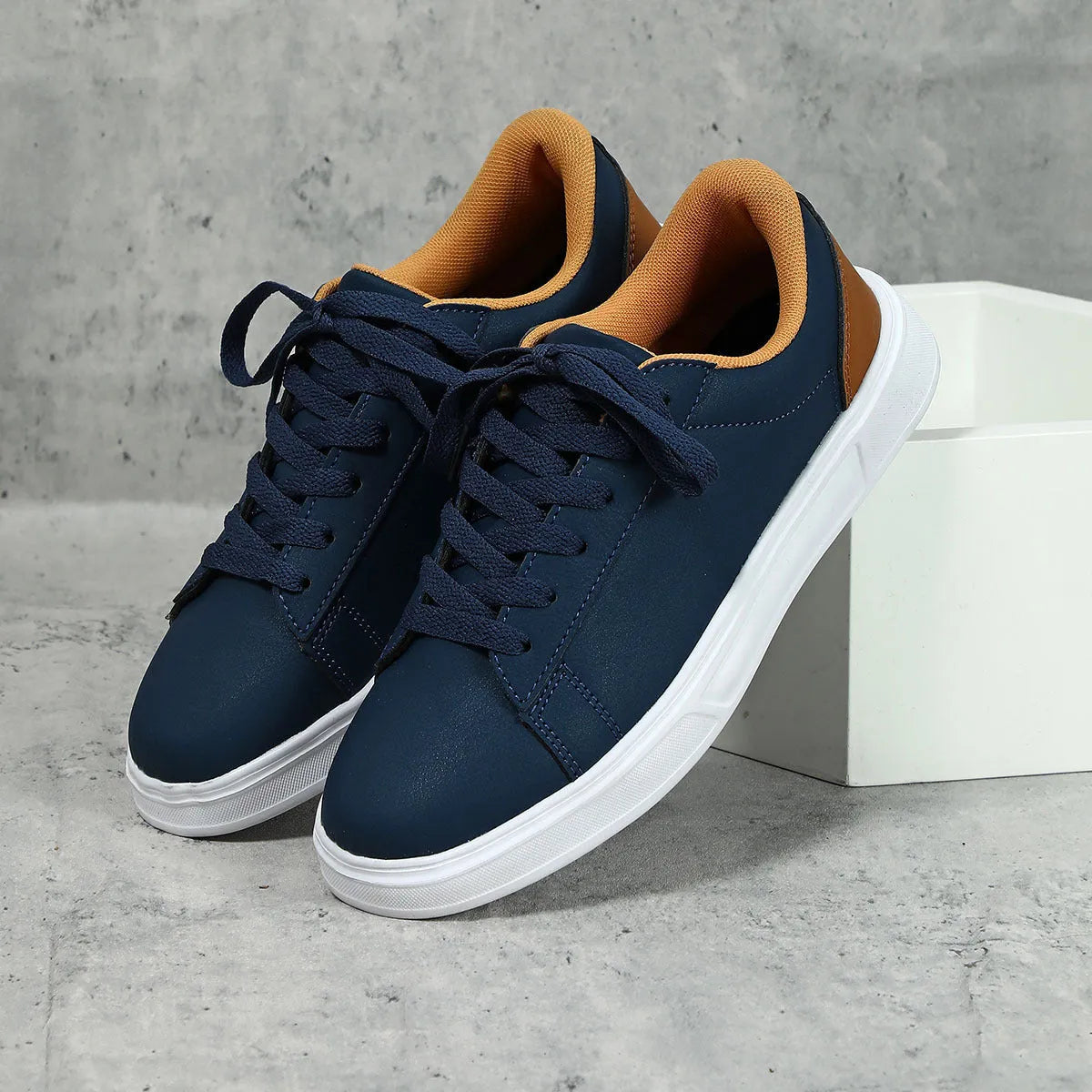 Beige brown platform skateboard sneakers with a cross-strap and round toe on a white background.