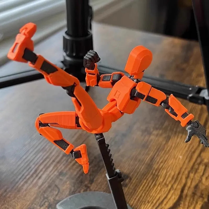 3D printed multi-jointed robot action figure model with movable joints on a desk.