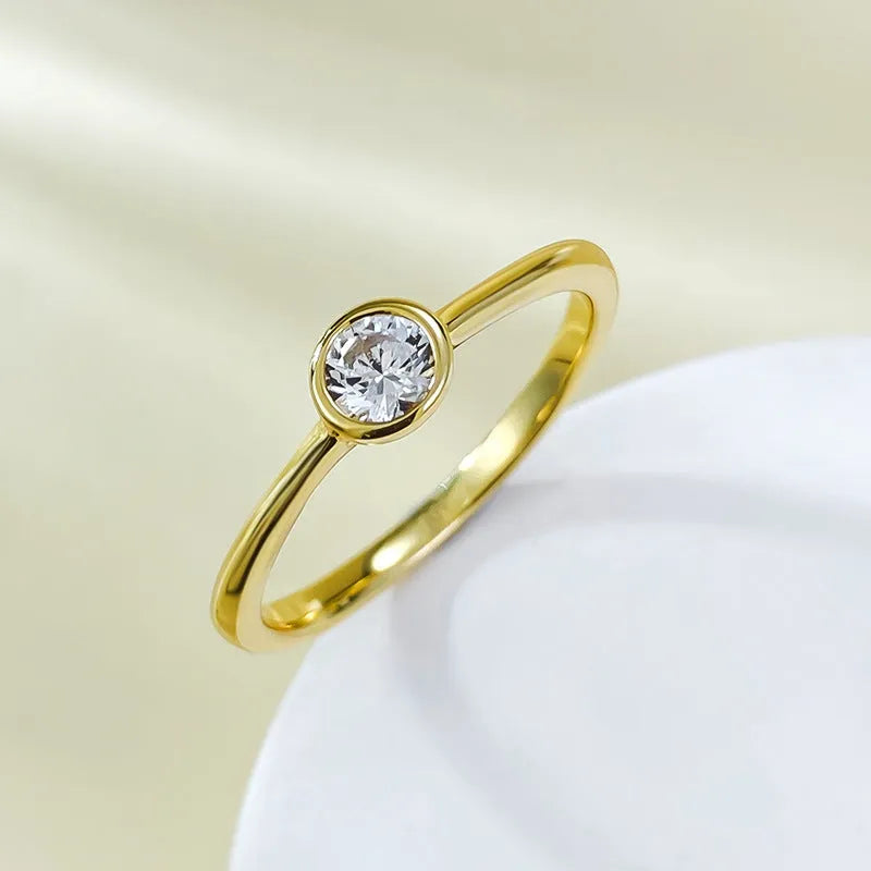 Minimalist crown-shaped silver ring in gold or platinum finish, shown in a simple setting.
