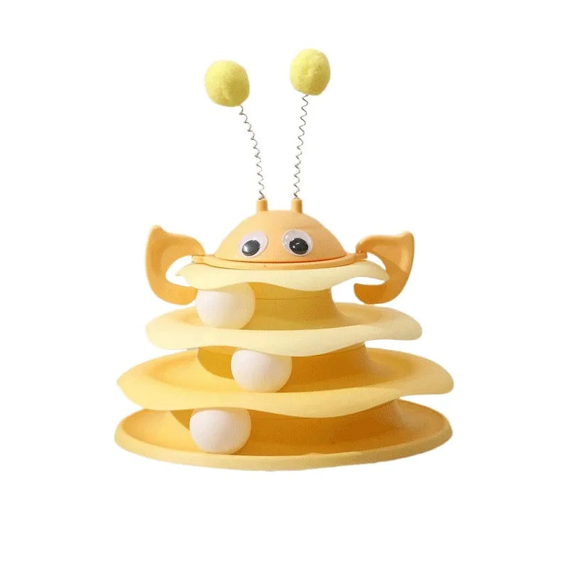 Cat toy tower with rotating bee toy and three-layer trackball in green plastic, placed on a wooden floor
