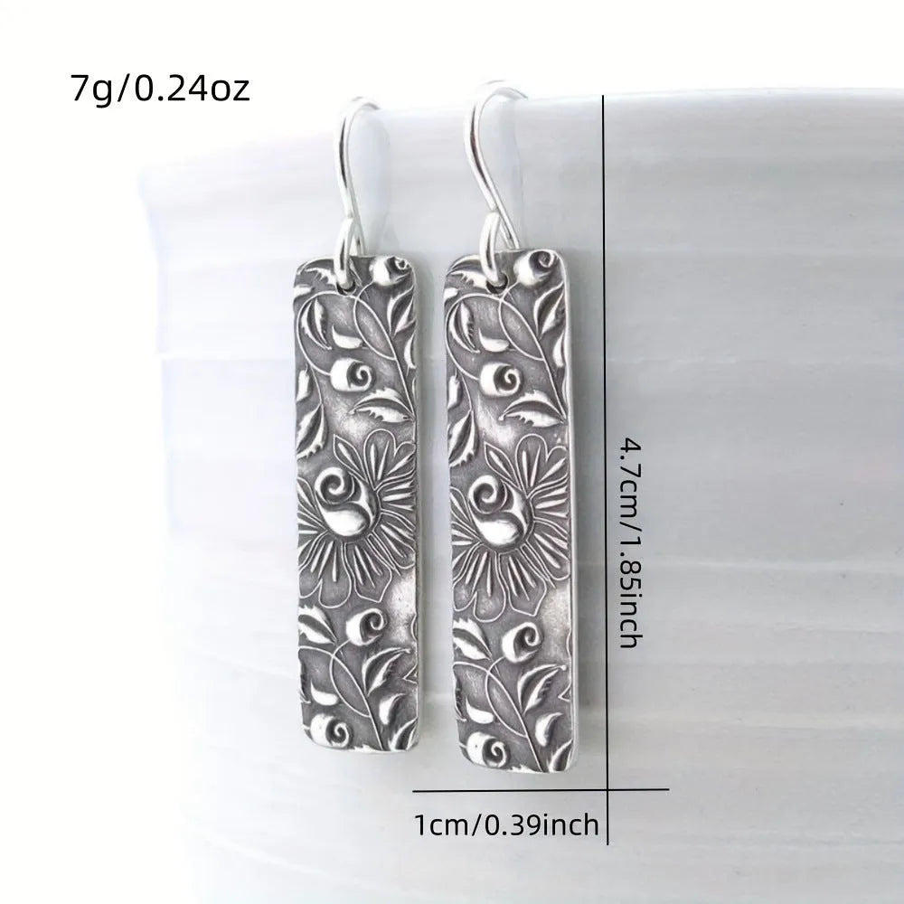 Silver long earrings with geometric shapes and carved vine detailing in zinc alloy construction
