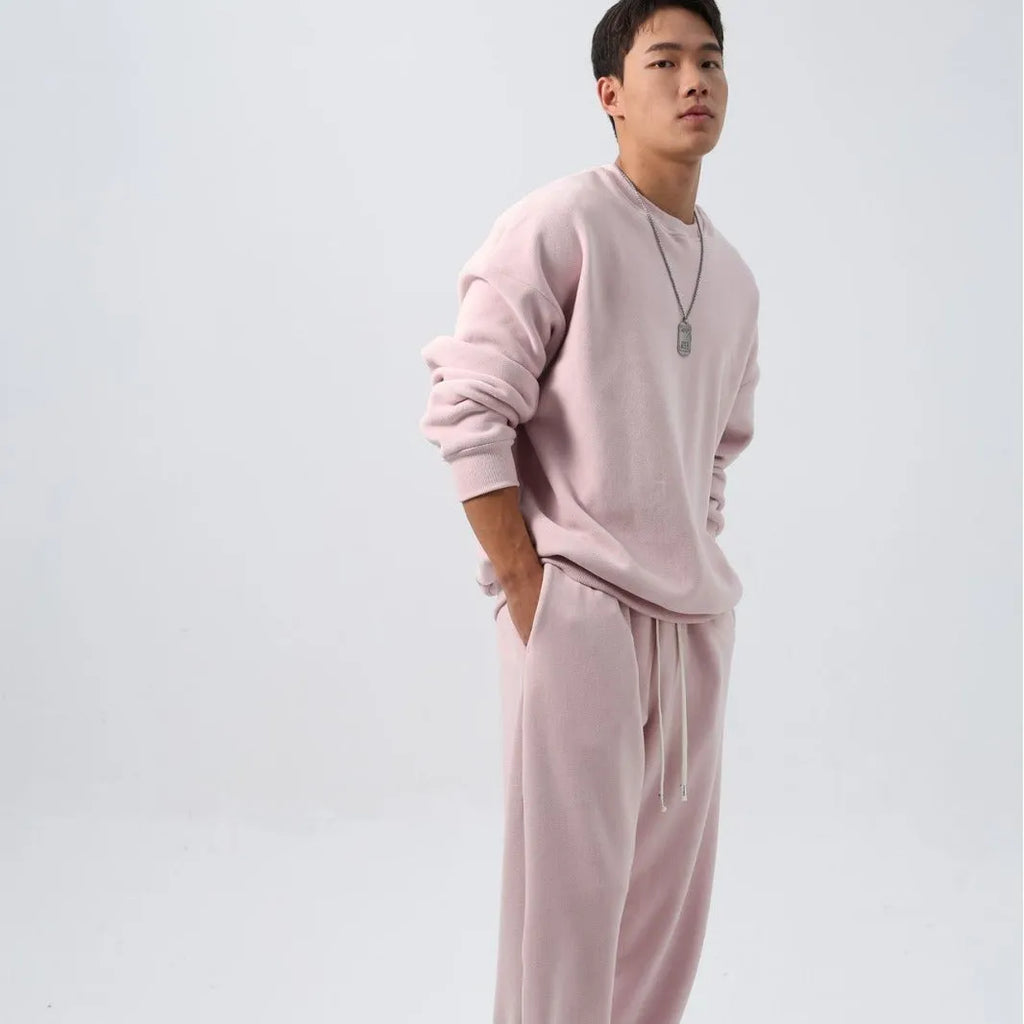 Men's black polar fleece sports suit set with long sleeve coat and loose trousers on a hanger.