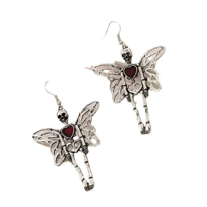 Pair of silver-coloured alloy earrings with exaggerated skull design on white background