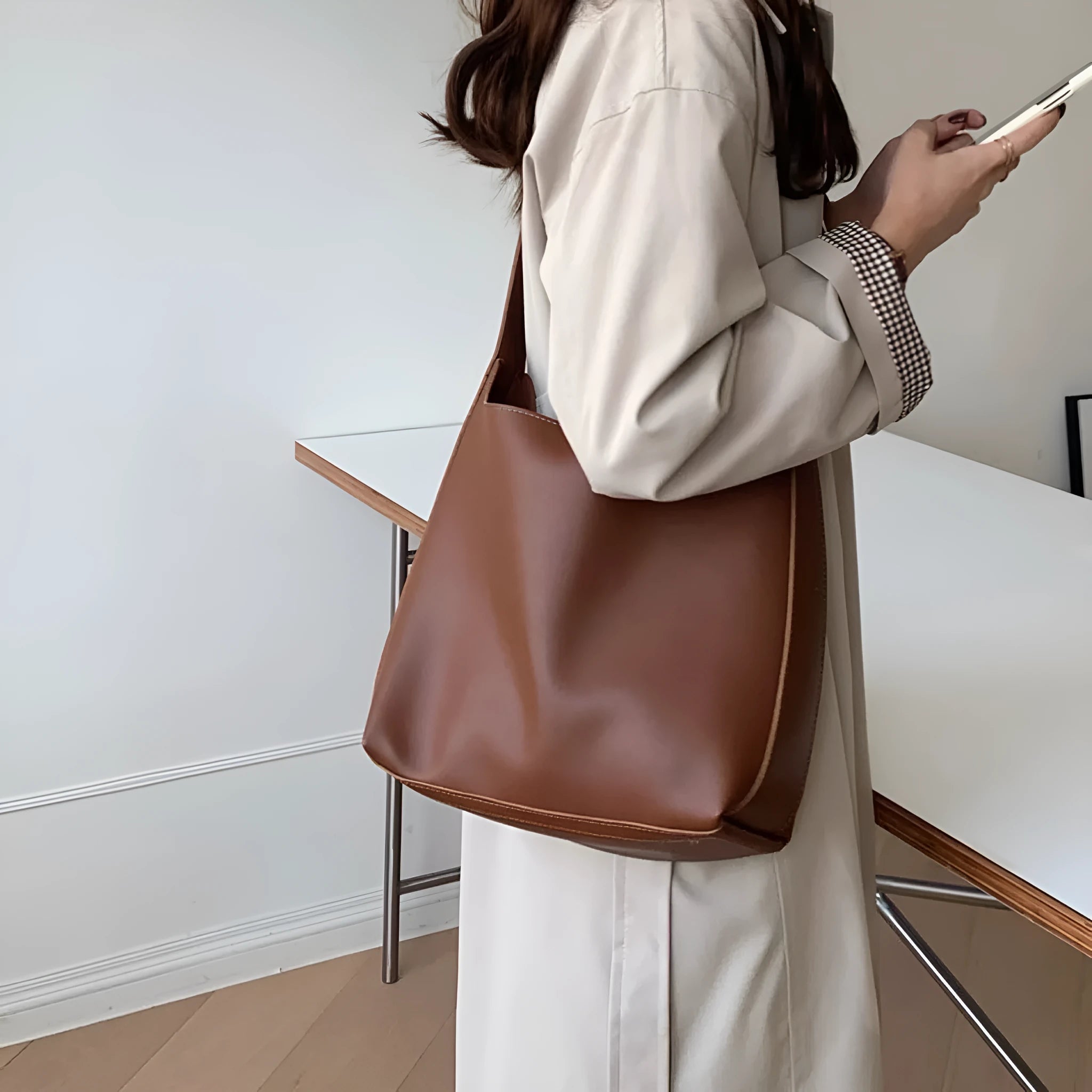 Women's soft PU shoulder bag with tassel detail in black and brown colour options