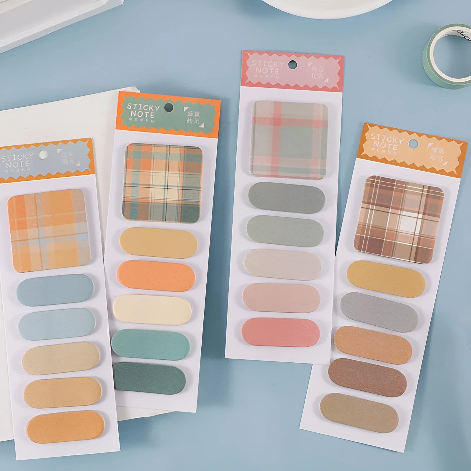 Set of six colourful plaid design sticky note pads, each sized 67mm by 200mm.