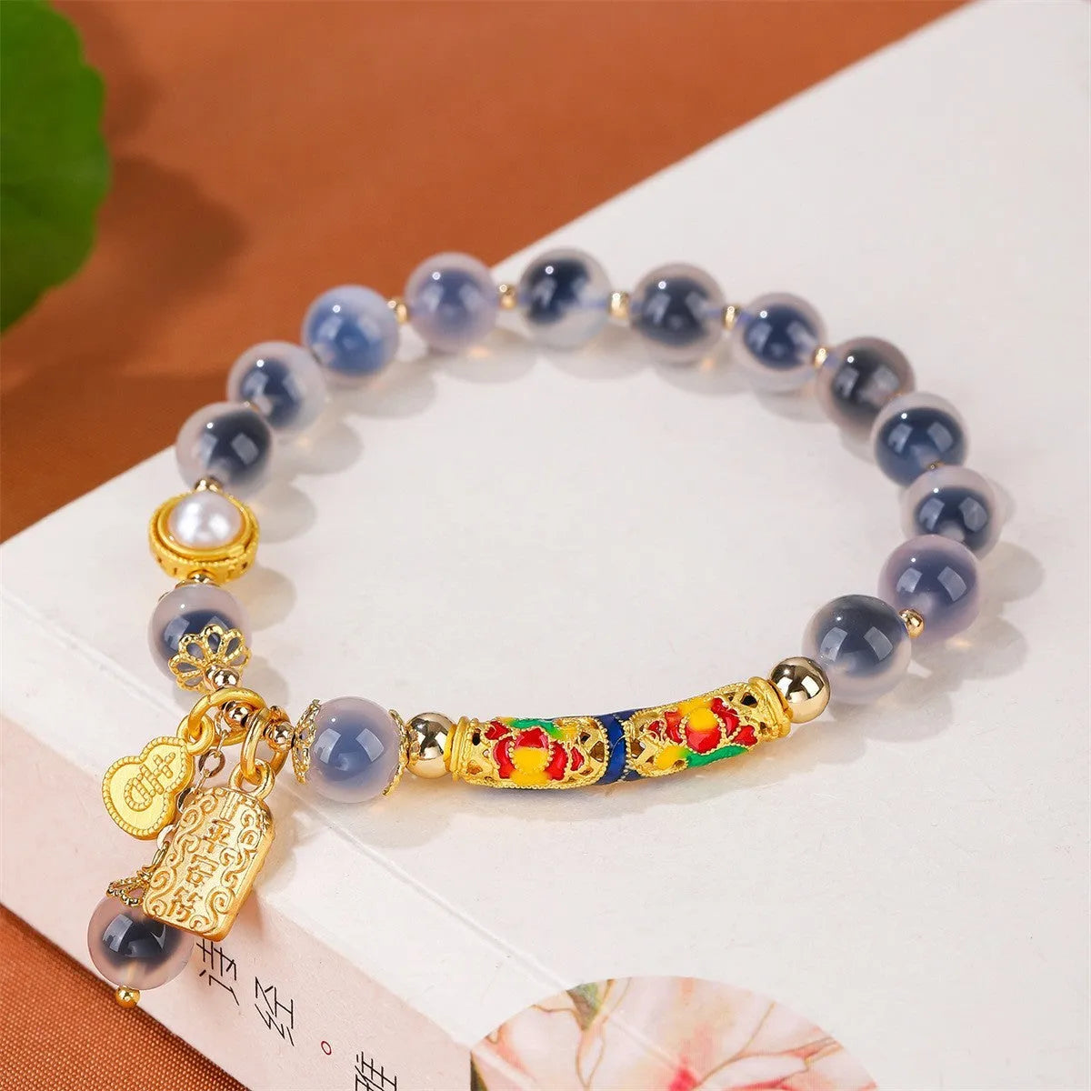 Handmade sugar heart agate bracelet with retro ethnic design on a wrist.
