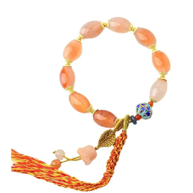 Vintage Tibetan agate bracelet with floral and geometric patterns including lily motif