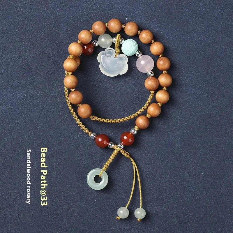 Hand-woven ebony double ring bracelet with traditional jade beads and Ruyi charm elements