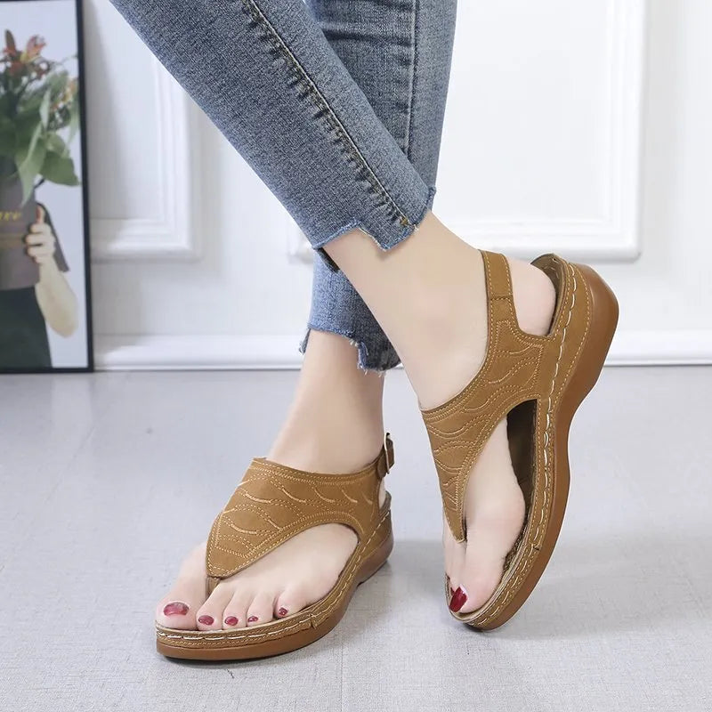 Women's black casual wedge heel sandals with an adjustable back strap buckle.
