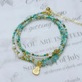 Close-up of a turquoise three-ring adjustable bracelet with a pull-out clasp on a wrist.