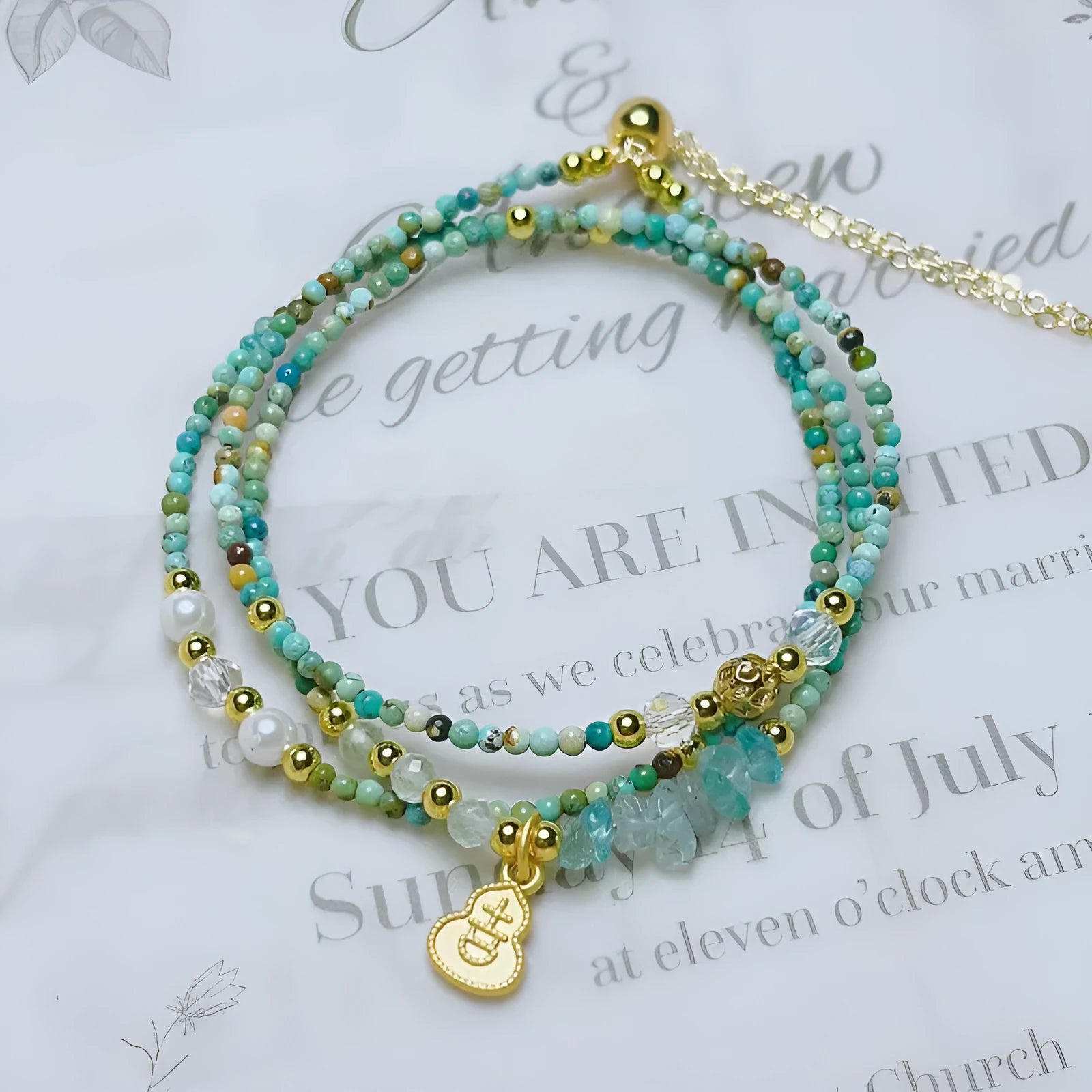 Close-up of a turquoise three-ring adjustable bracelet with a pull-out clasp on a wrist.