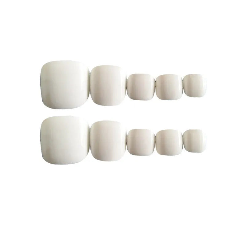 Set of white artificial false nails with a starry sky pattern, ready for application.