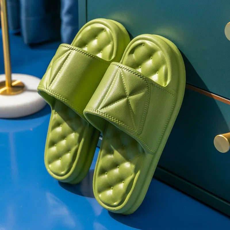 A pair of soft EVA bathroom slippers with a thick sole, shown in a choice of colours including black, caramel, green, pink, and yellow.