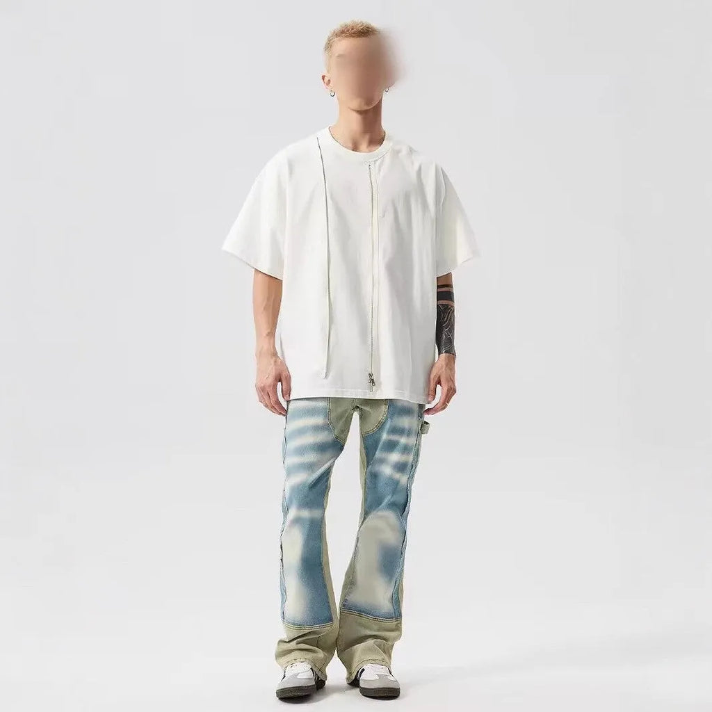 Yellow and blue retro patchwork jeans with a splash-ink damaged design on a mannequin.
