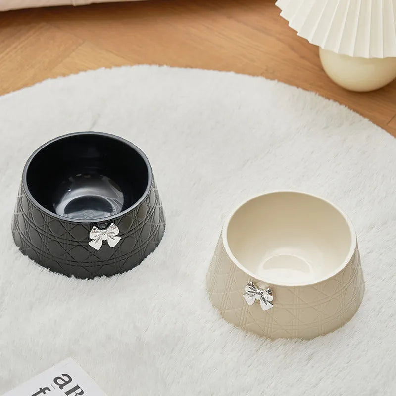 Diamond pattern pet feeding bowl with a bowknot decoration in black, purple or white with a pink or silver bow.