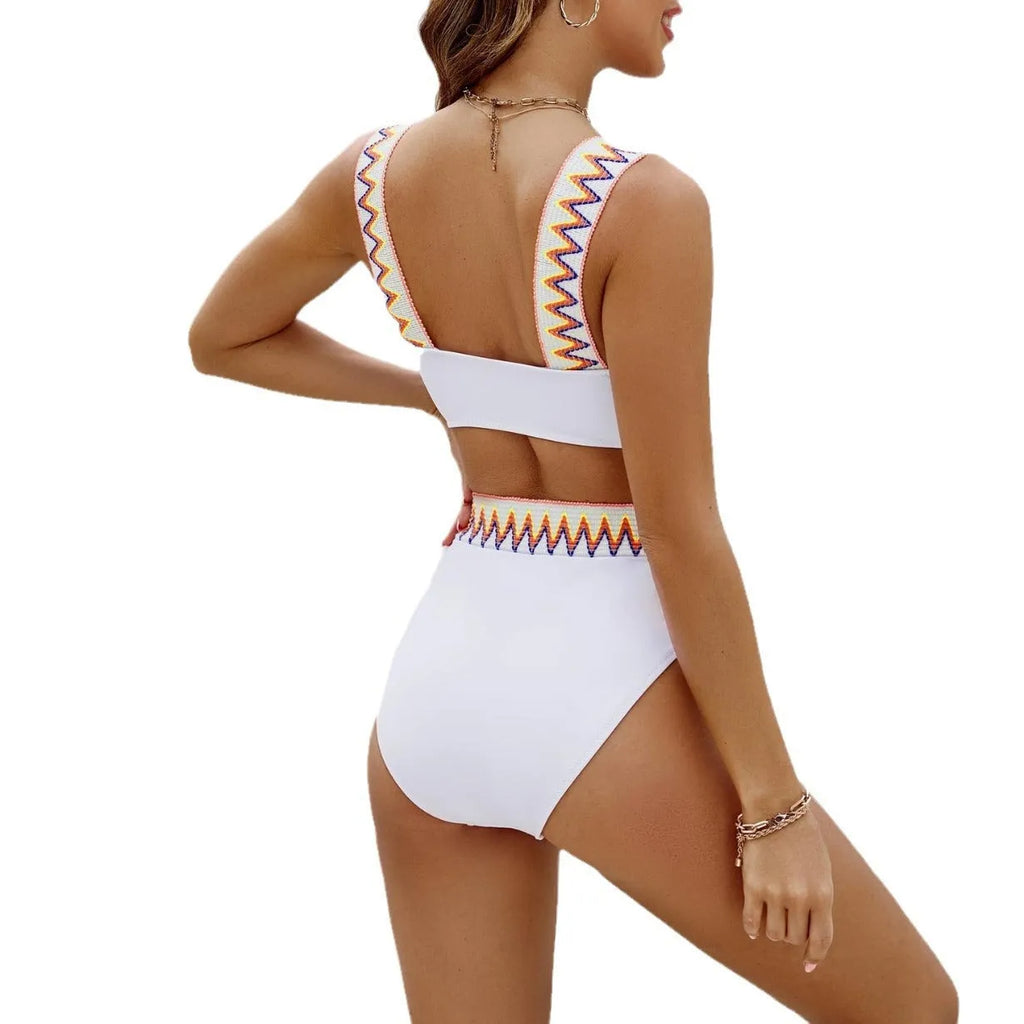 Black and white women's lace-up front bikini with high-waisted swim shorts.