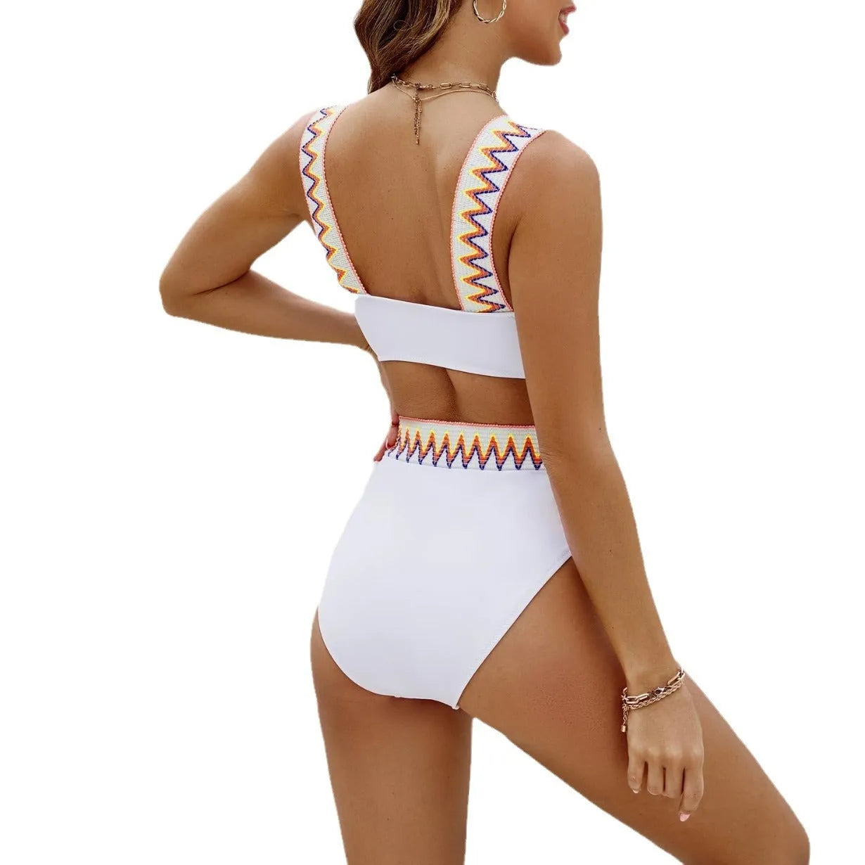 Black and white women's lace-up front bikini with high-waisted swim shorts.