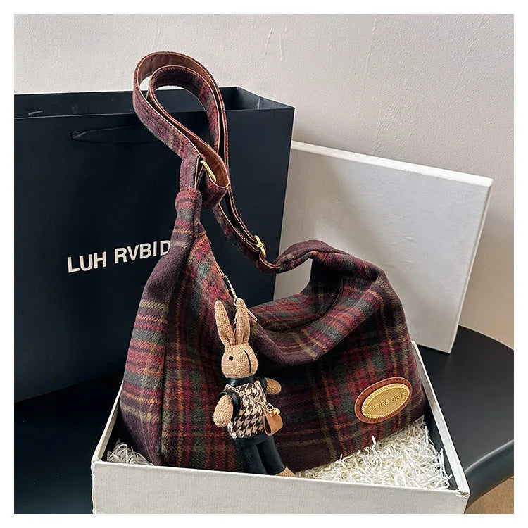 Women's woolen shoulder bag in horizontal square shape with cross-body strap and decorative sewing lines