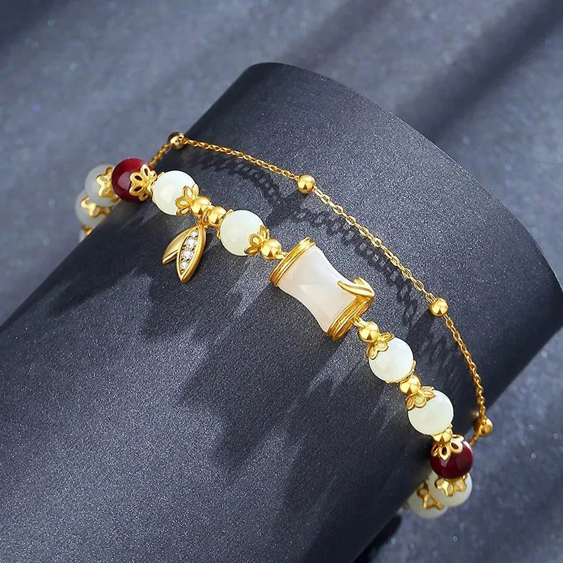 Bamboo-themed glass bracelet with coloured glaze beads and electroplated flower charm