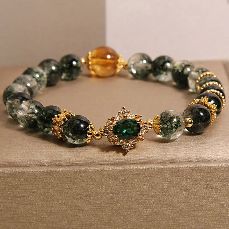 Gold rutilated quartz bracelet with green phantom quartz and ruby quartz crystal beads, pearl accents, and gold-plated detailing