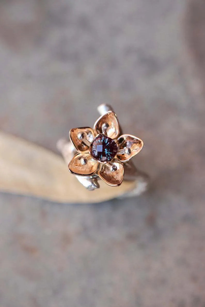 Silver two-tone alloy ring with a geometric floral pattern on a model's hand.