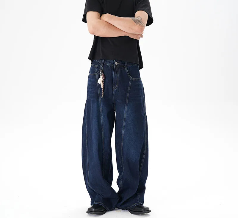 Dark blue washed distressed wide leg machete jeans showing denim fabric texture and wide leg silhouette